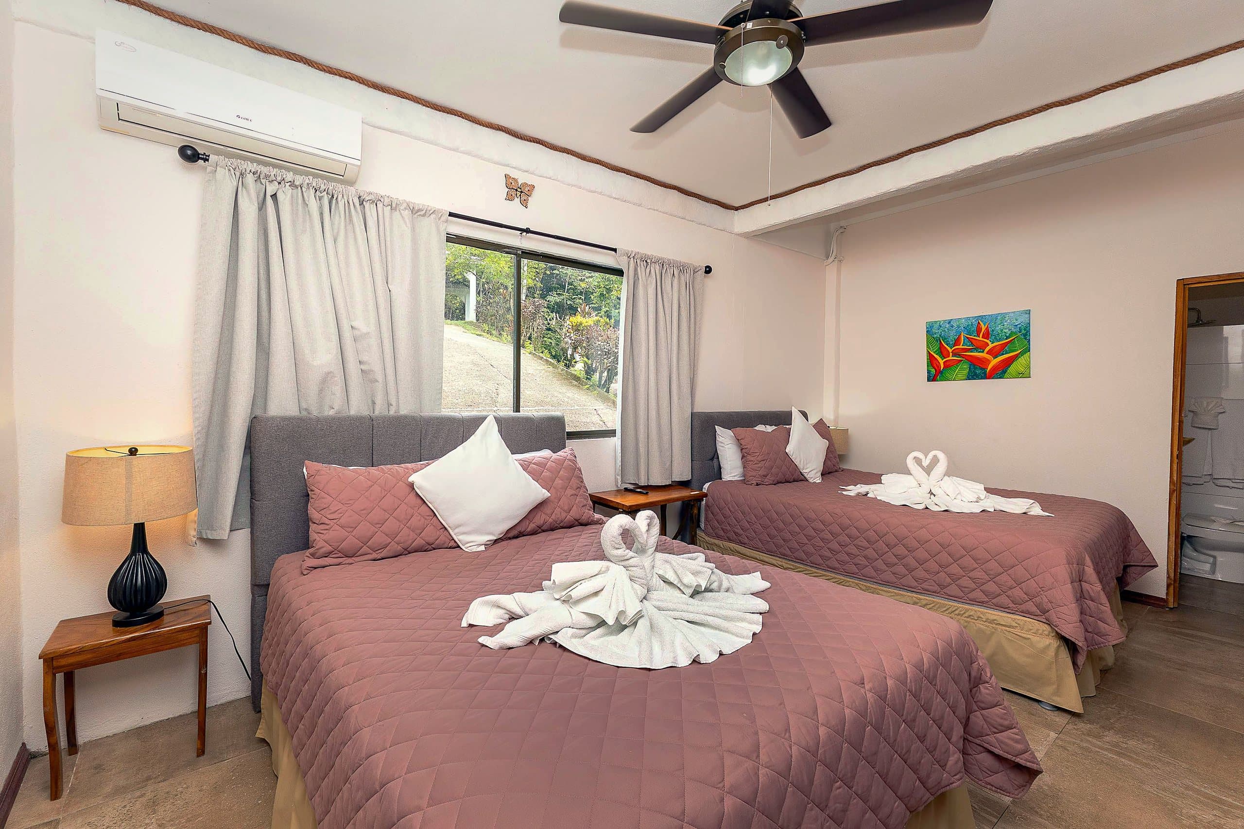 Habitación con dos camas y arte de heliconias